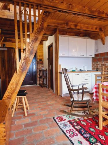 a living room with a staircase and a kitchen at Vikendica Tromedja Pale in Pale