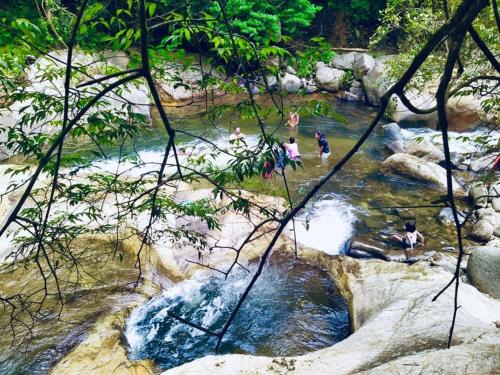 a group of people swimming in a river at Bambara Ella Agro Resort & Camping in Haputale