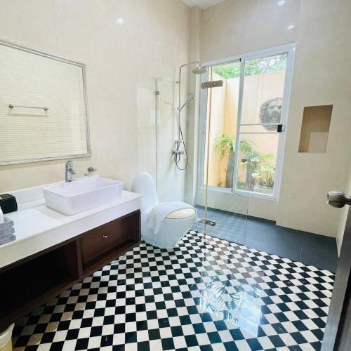 a bathroom with a sink and a toilet and a shower at Baan Ing Khao in Pak Chong