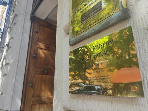 a poster for a museum of a house on a wall at Vatican museum guest house in Rome