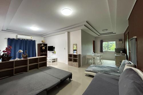 a bedroom with a bed and a desk in it at Tann Anda Resort in Thalang