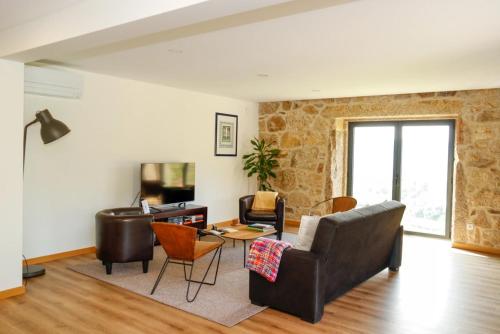 a living room with a couch and a table at Casa Da Belina : casa de ferias com piscina, Labruja, Ponte de Lima in Ponte de Lima