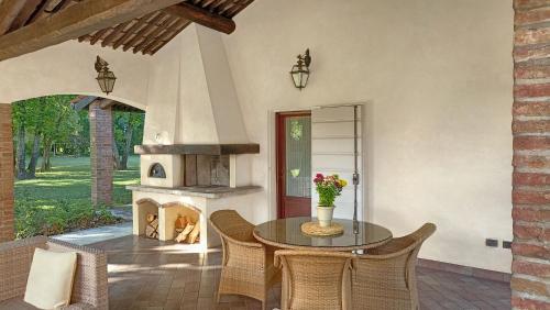 a dining room with a table and a fireplace at La casetta nel bosco in Mantova