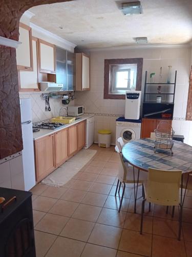 a kitchen with a table and a table and chairs at T3 N16 Ref 008 in Tavira