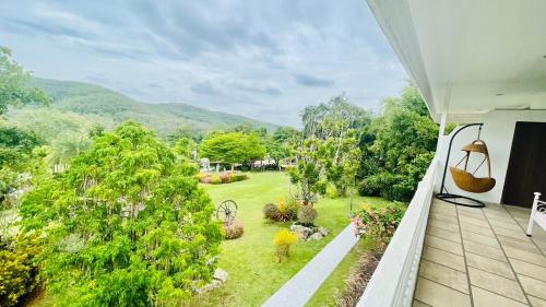 a view of a garden from the balcony of a house at Baan Ing Khao in Pak Chong
