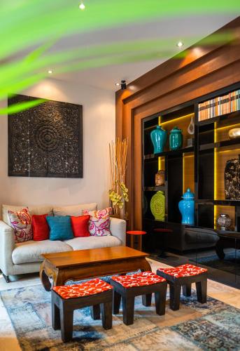 a living room with a couch and a coffee table at Mala Garden Design Hotel in Siófok