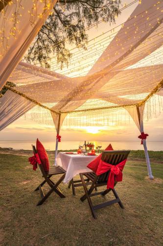 a table and two chairs under a tent at JW Marriott Phuket Resort and Spa in Mai Khao Beach
