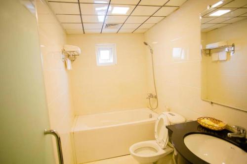 a bathroom with a sink and a toilet and a tub at Kim Liên - Số 7 Đào Duy Anh - by Bay Luxury Hotel in Hanoi