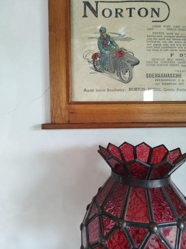 a picture of a man riding a motorcycle in a vase at Dalem Arum (for women only) in Bandung