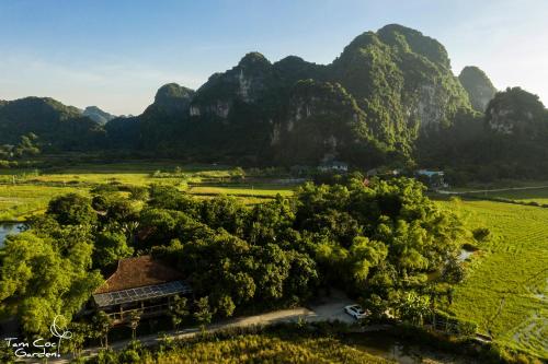 an aerial view of a farm with mountains in the background at Tam Coc Garden Resort in Ninh Binh