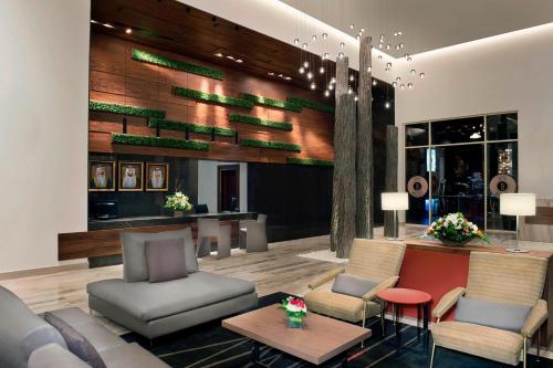 a lobby with couches and chairs and a table at Marriott Executive Apartments Dubai Creek in Dubai