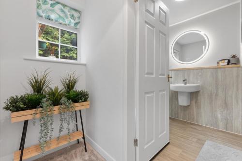 Łazienka z białymi drzwiami i umywalką w obiekcie Silver Stag Properties, Luxurious 3 BR Bungalow w mieście Worthington