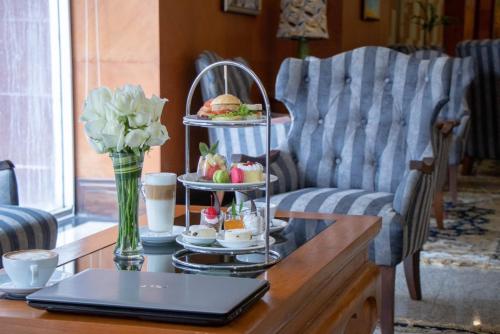 a coffee table with a tray of food on it at Duangtawan Hotel Chiang Mai in Chiang Mai