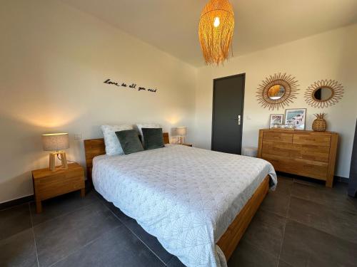 a bedroom with a bed and a mirror on the wall at Le Bellevue in Saint-Paul-de-Vence