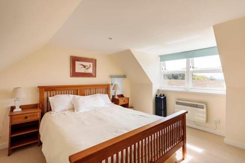 a bedroom with a large bed and a window at Blackhill Farm Cottage in Perth