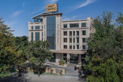 a building with a sign on top of it at Hyatt Centric Rajpur Road Dehradun in Dehradun