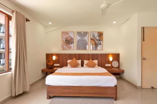 a bedroom with a large bed and a window at Paradiso Villa -2BHK villa with Pool-Vagator By StayMonkey in Vagator