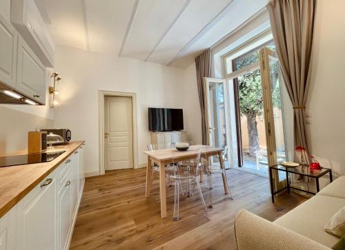 a kitchen with a table and a dining room at Palazzo Pitagora in Taranto