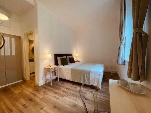 a bedroom with a bed and a wooden floor at Palazzo Pitagora in Taranto