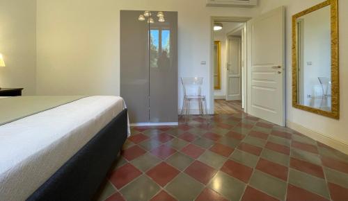 a bedroom with a bed and a checkered floor at Palazzo Pitagora in Taranto