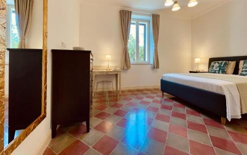 a bedroom with a bed and a mirror on the floor at Palazzo Pitagora in Taranto