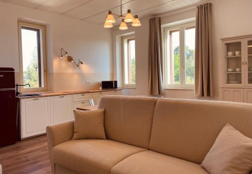 a living room with a couch and some windows at Palazzo Pitagora in Taranto