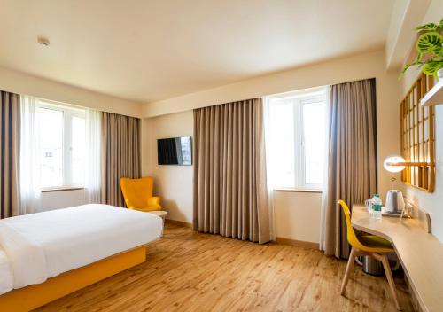 Un ou plusieurs lits dans un hébergement de l'établissement Bloom Hotel - Jammu