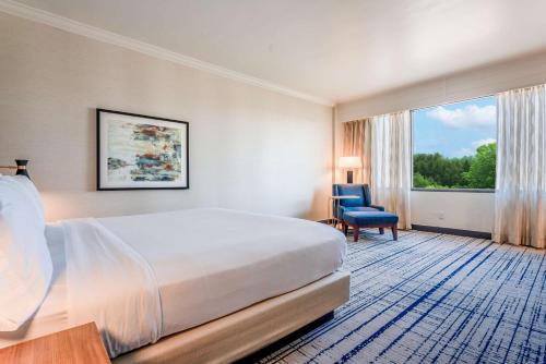 a hotel room with a bed and a window at DoubleTree by Hilton South Charlotte Tyvola in Charlotte
