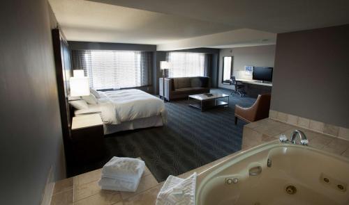 a hotel room with a bed and a bath tub at DoubleTree by Hilton Bloomington Minneapolis South in Bloomington