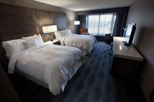 a hotel room with two beds and a television at DoubleTree by Hilton Bloomington Minneapolis South in Bloomington