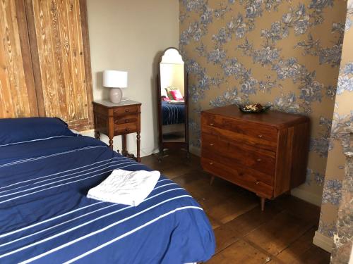 a bedroom with a bed and a dresser and a mirror at Résidence étoile in Saint-Yrieix-la-Perche