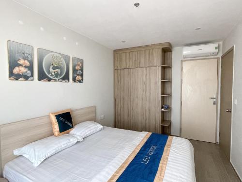 a bedroom with a large bed and a closet at Leo House - The Song Building 28 Thi Sách in Vung Tau