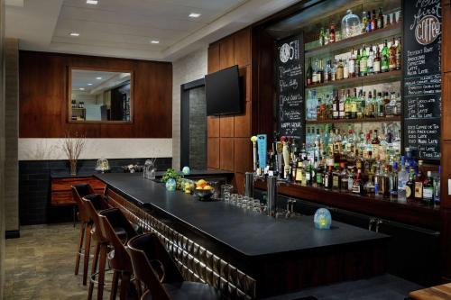 a bar in a restaurant with a lot of alcohol at Distrikt Hotel New York City, Tapestry Collection by Hilton in New York