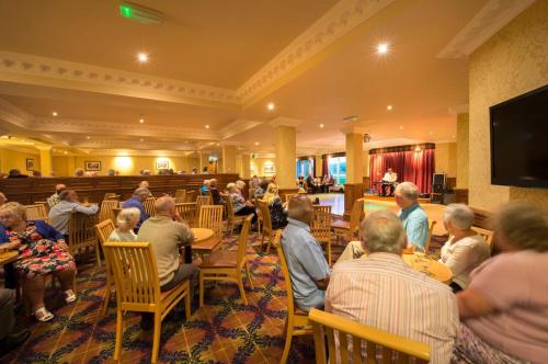 a group of people sitting at tables in a restaurant at Loch Tummel Hotel in Tummel Bridge