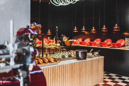 a bakery with a buffet of pastries on display at Tremonti Hotel Karpacz in Karpacz