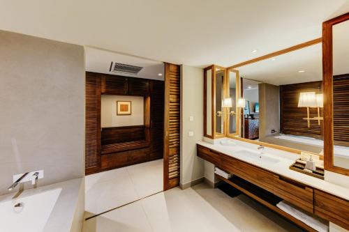 a bathroom with a sink and a mirror at Cinnamon Bentota Beach - Signature Selection in Bentota