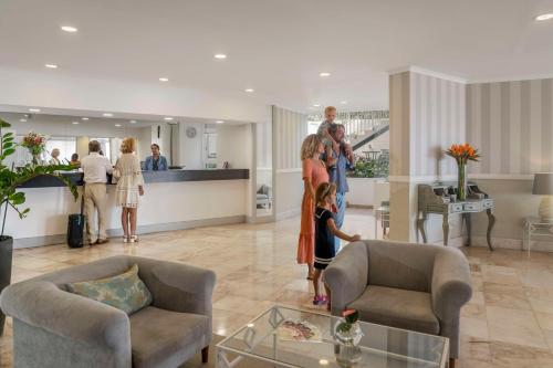 a group of people standing in a living room at Florasol Residence Hotel - Dorisol hotels in Funchal