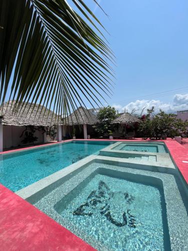 a swimming pool with a painting in the middle at Villa Euphoria - Adults Only in Paje