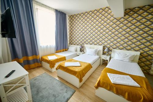 Postel nebo postele na pokoji v ubytování Hotel Evianne Boutique