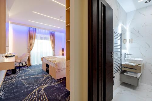 a hotel room with a bed and a desk at Diamond Panzió in Hajdúszoboszló