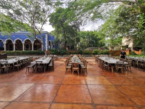 a courtyard with tables and chairs in a park at Hacienda San Jose Cholul in Tixkokob
