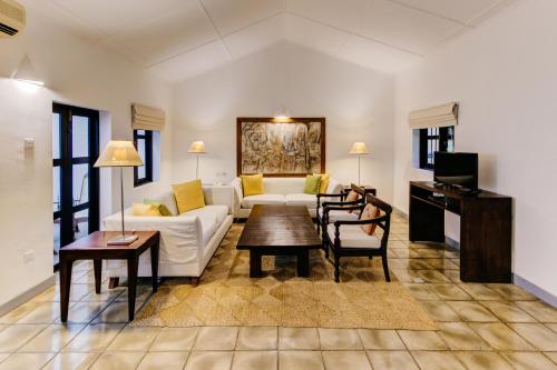 a living room with a couch and a table at Habarana Village by Cinnamon in Sigiriya