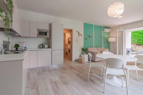 a kitchen and living room with a table and chairs at Ninfea Apartments by Wonderful Italy in Lezzeno
