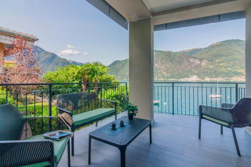 a balcony with chairs and a view of the water at Ninfea Apartments by Wonderful Italy in Lezzeno