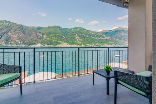 a balcony with a view of the water and mountains at Ninfea Apartments by Wonderful Italy in Lezzeno