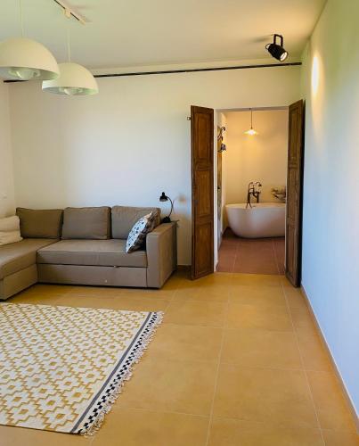 a living room with a couch and a bath tub at Relaxing house with exclusive swimming pool, close to Imola and Faenza, 4 bathrooms in San Mauro