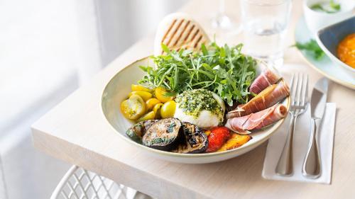 a plate of food sitting on top of a table at Holiday Inn Frankfurt - Alte Oper by IHG in Frankfurt/Main