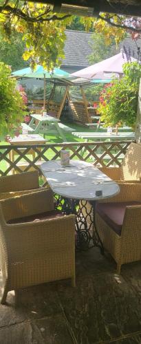 a table and two chairs and a table and a table and chairs at The Inn West End in Woking