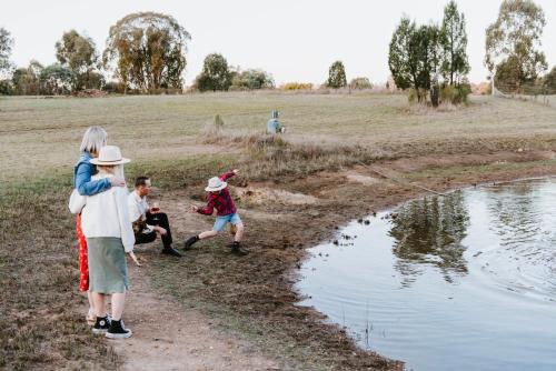 a group of people standing around a body of water at 'Wilpine' Poolside Country Luxury near Town in Mudgee
