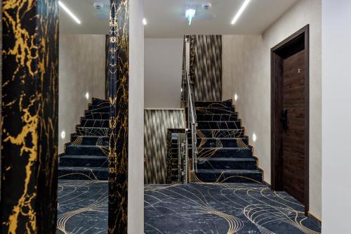a set of stairs with blue and gold carpet at Diamond Panzió in Hajdúszoboszló